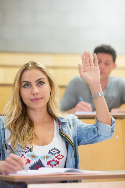 Attractive student raising hand