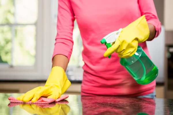 Woman cleaning the counter