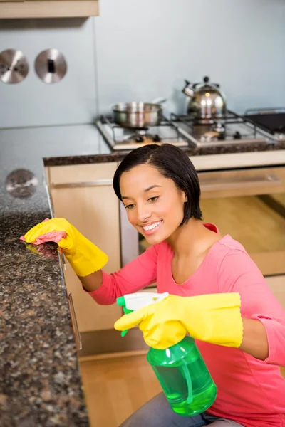 Brunette cleaning kitchen counter