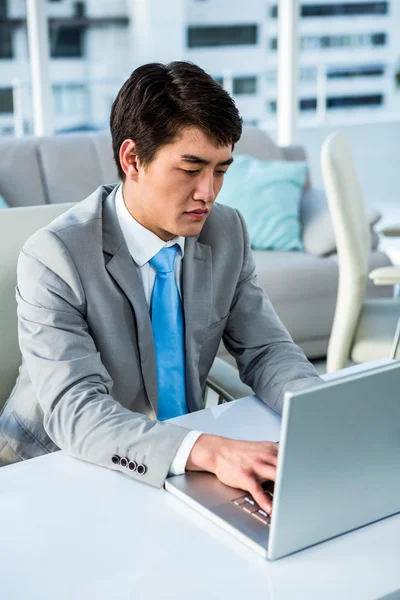 Concentrated businessman typing on computer