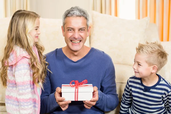 Father holding gift given by children