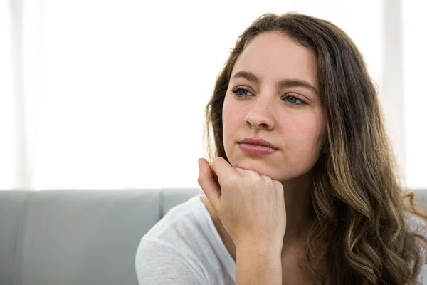 Woman thinking with hand on chin