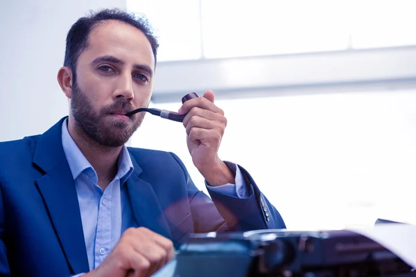 Businessman using typewriter