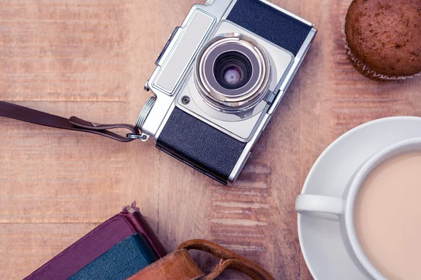 Old camera with diaries and coffee