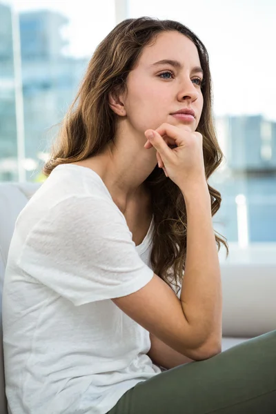 Woman thinking with hand on chin