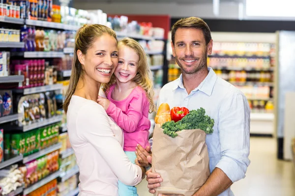 Family with grocery bag at supermarket