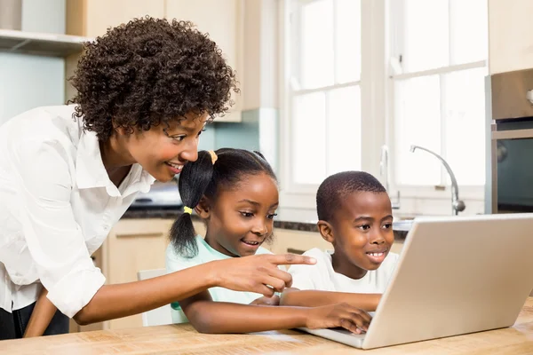 Family using laptop in the kitchen