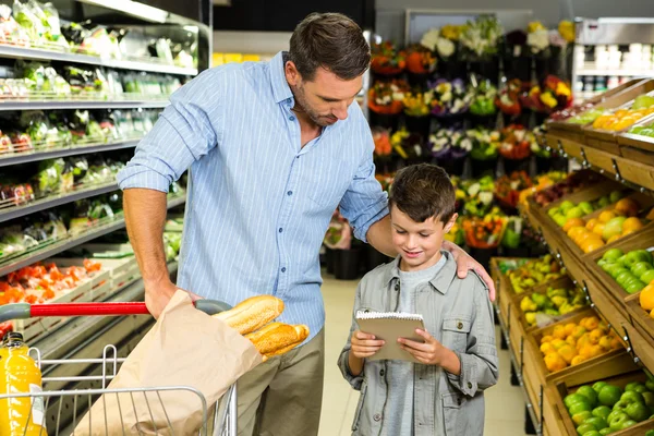 Father and son reading grocery list