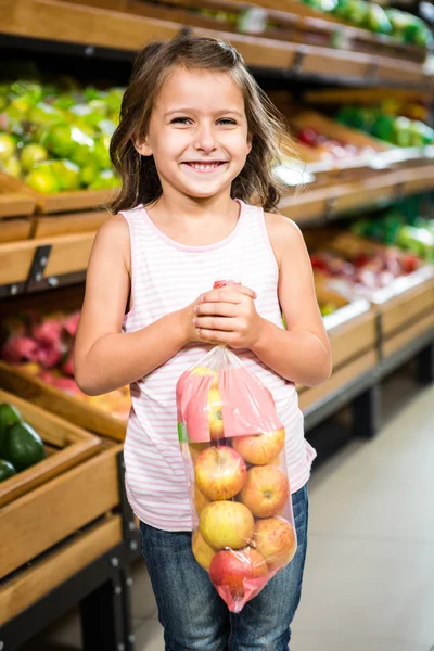 Little girl holding apple