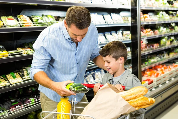 Father and son doing grocery shopping