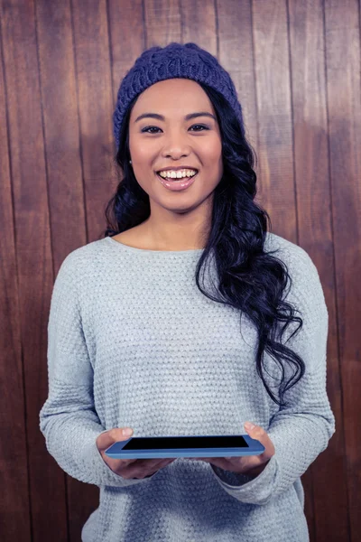 Asian woman holding tablet