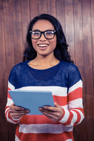 Asian woman holding tablet