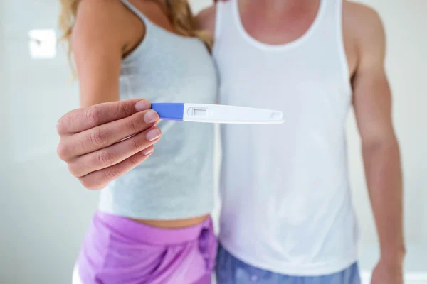 Couple showing pregnancy test