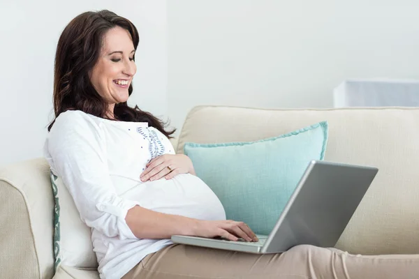 Pregnant woman resting on couch