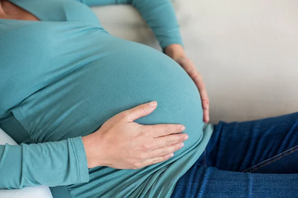 Pregnant woman touching her belly