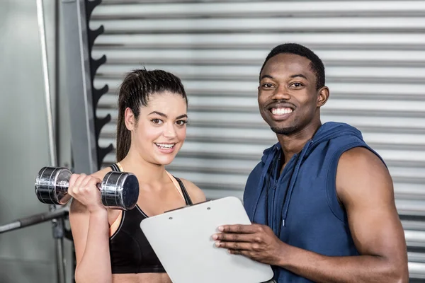 Trainer explaining workout plan to woman