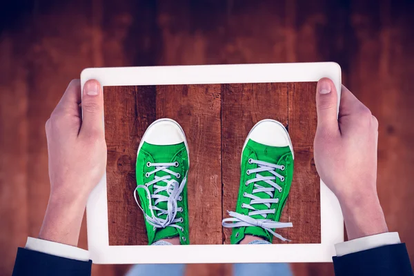 Feminine hands holding tablet