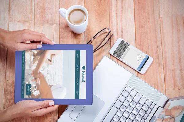 Feminine hands holding tablet