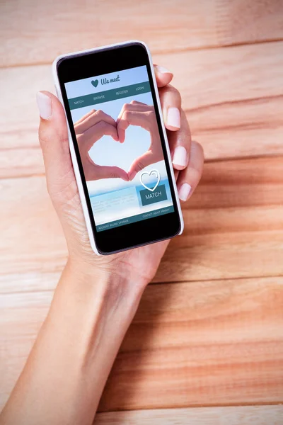 Feminine hand holding smartphone