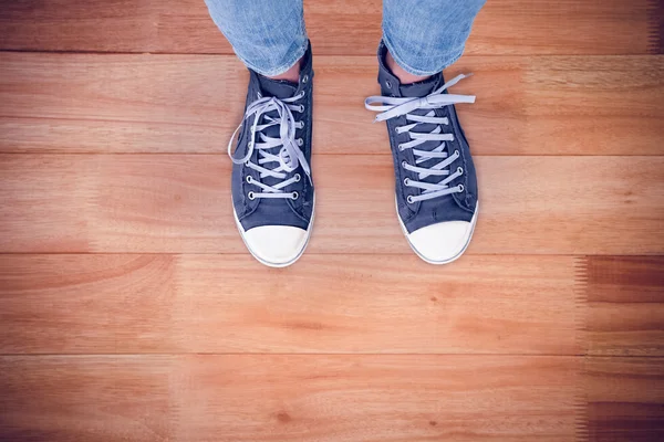 Casual shoes against wooden flooring