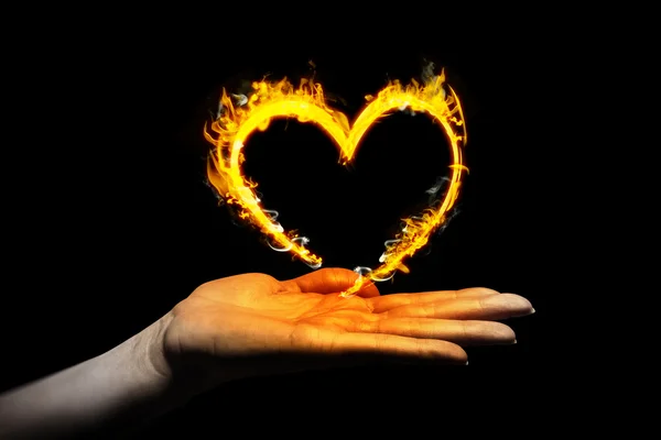 Hand showing heart in fire