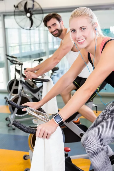 Fit couple using exercise bikes