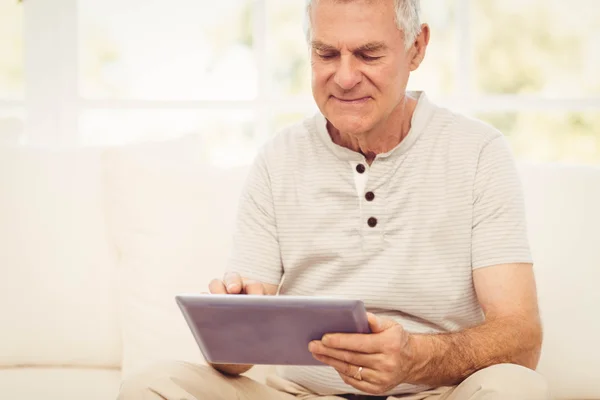Smiling senior man using tablet