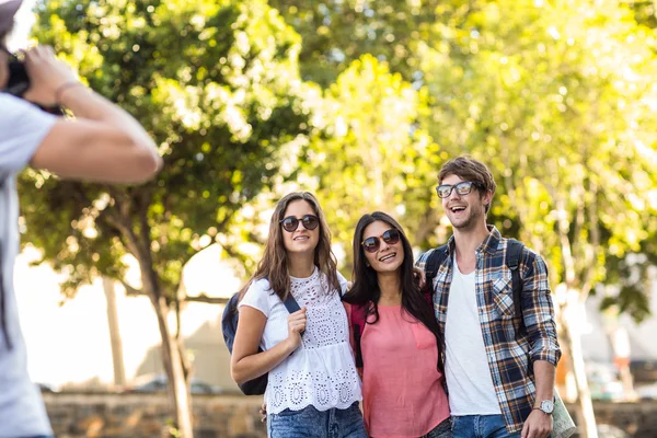 Hip man taking picture of his friends