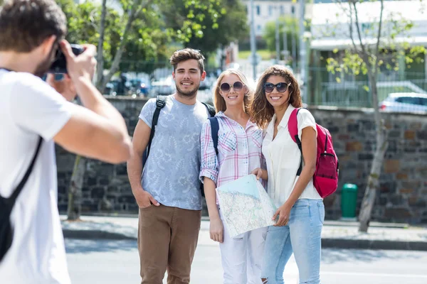 Hip man taking picture of his friends