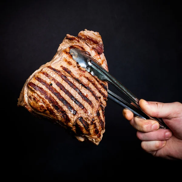 Large piece of fresh beef meat prepared on a grill pan. Toned