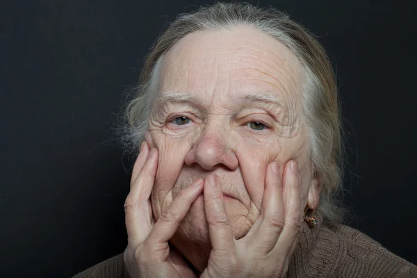 Portrait of elderly woman on dark background
