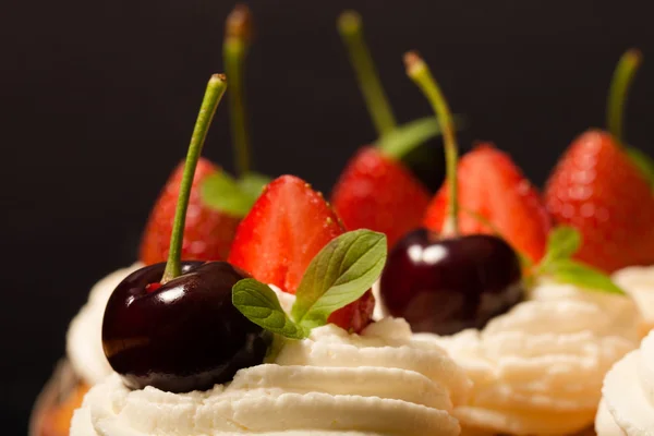 Fresh cupcakes with cream and berries. Shallow depth of field. S