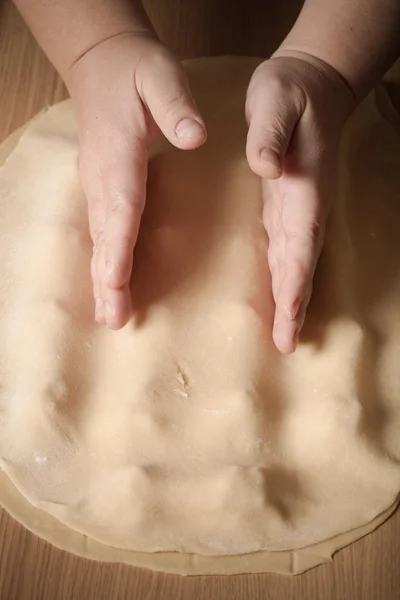 Female hands cut up dough. Toned