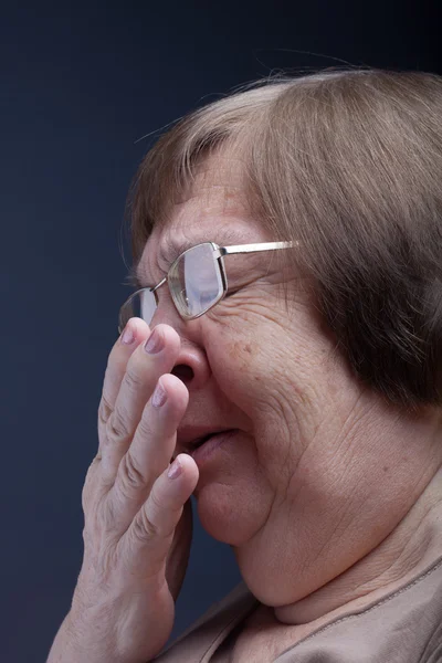 Portrait of elderly woman. Sneeze