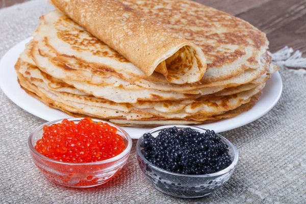Russian pancakes - blini with red and black caviar
