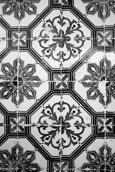 Old ceramic tile with black-and-white pattern