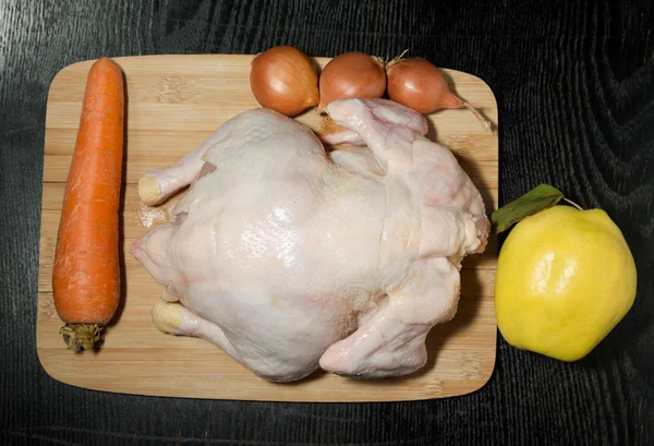 Fresh whole chicken with fruit and vegetables is prepared for co