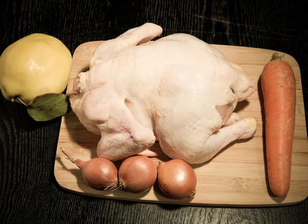 Fresh whole chicken with fruit and vegetables is prepared for co