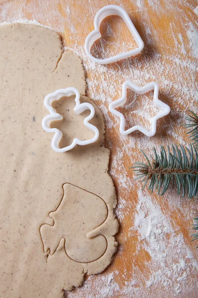 Dough for gingerbread cookie and cookie cutters in different sha
