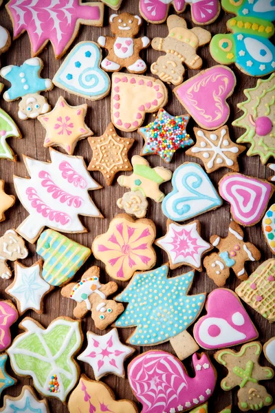 Gingerbread homemade cookies with icing colored drawings on wood