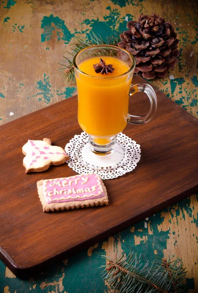 Glass of sea buckthorn beverage (kissel) and colored gingerbread