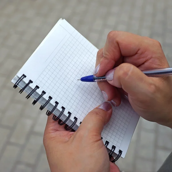 Recording pen in a notebook in the box spring.