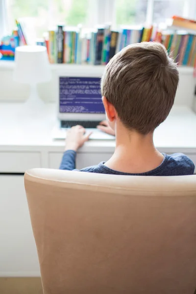 Teenage Boy In Bedroom Writing Computer Code