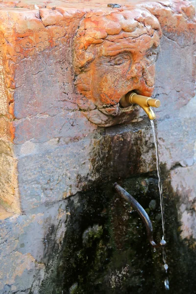 Public drinking water from a Italian fountain faucet