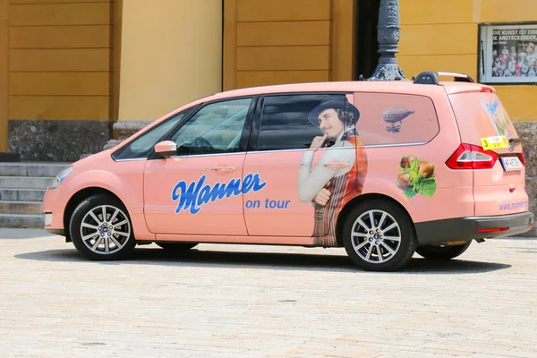 A pink car with sticker Manner on tour parking in Innsbruck, Austria