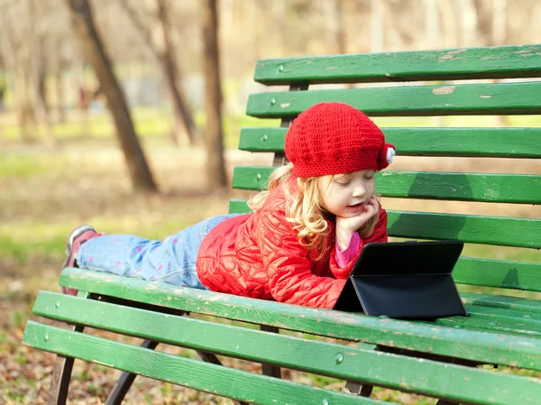 Kid with technology outdoors