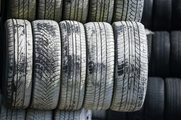 Stack of old wheel black tyre texture background