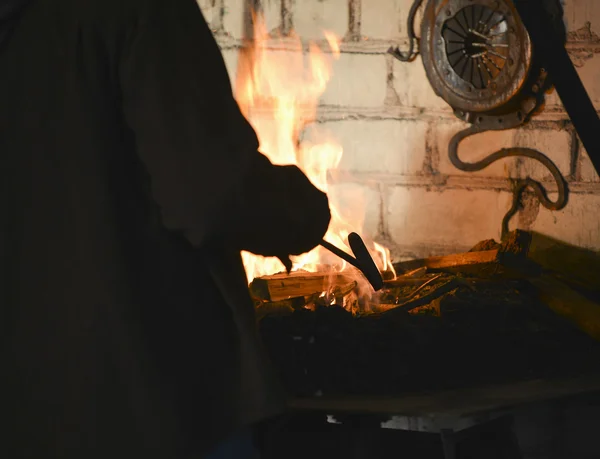 Blacksmith forges a red-hot iron