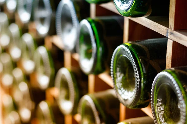 Wine bottles stacked on wooden racks