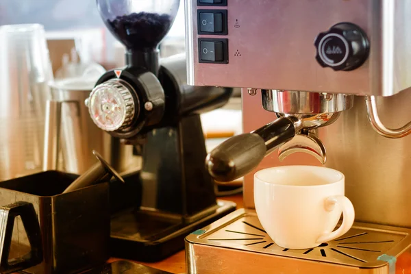 Closeup of espresso preparing in coffee machine